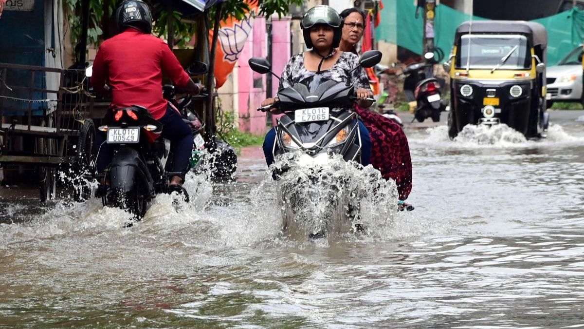 Vehicles wade through a flooded road near Killippalam on Monday following heavy rain in Thiruvananthapuram