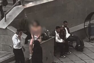 Iranian Woman: Iranian woman strips in protest over assault by security forces for improper hijab; arrested